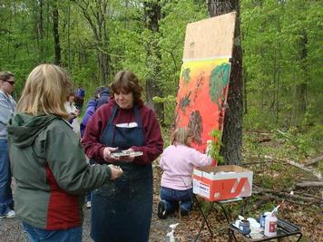 Students painting forest scene