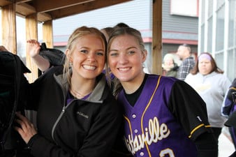 Lucy Vanatta and Brooke Grossman posing for a picture at their softball game
